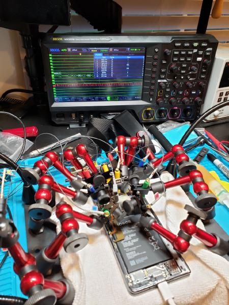 Sometimes you need four extra pairs of hands to figure out what's happening inside these tiny phones. A digital analyzer does most of the heavy lifting, but it's still up to the engineer to interpret what the data bits are doing.